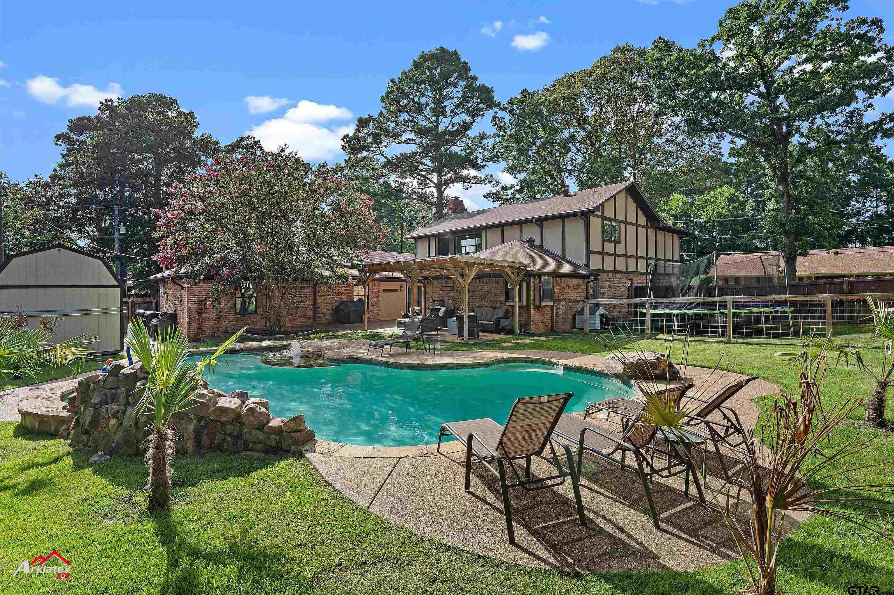 914 Regency Drive Longview, TX 75604 - Photo 33 of 35 a view of a house with backyard sitting area and garden