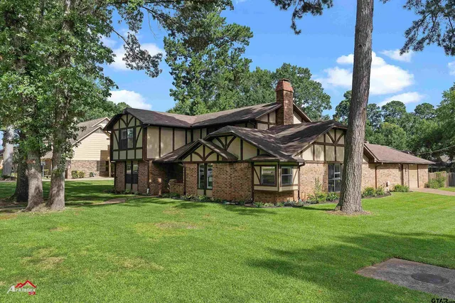 a front view of house with a garden
