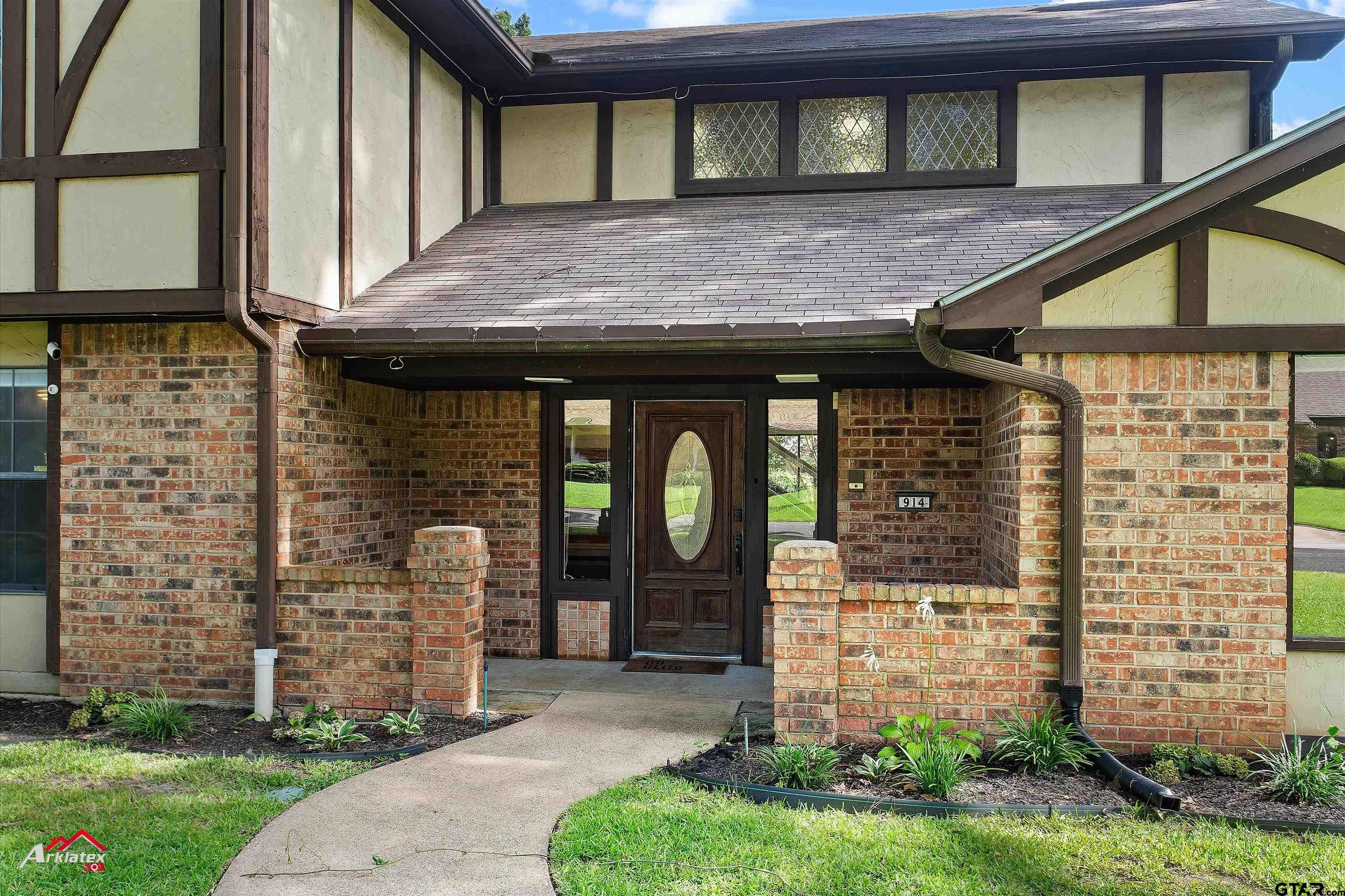 914 Regency Drive Longview, TX 75604 - Photo 6 of 35 a front view of a house with garden