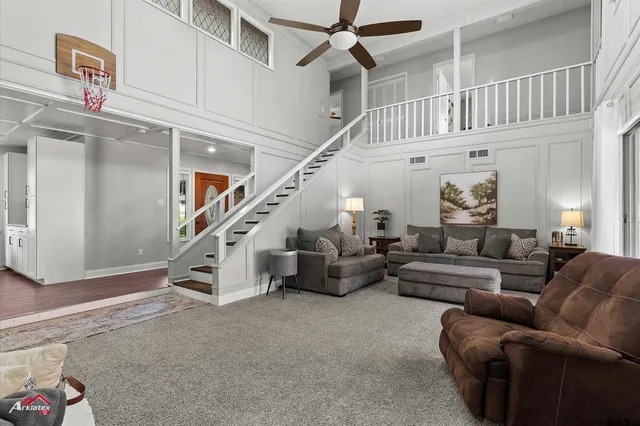 a living room with furniture and stairs