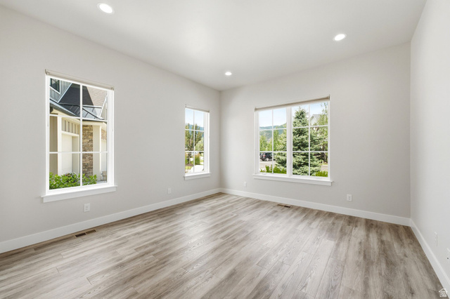 496 North Farmhouse Way, Unit 11 Midway, UT 84049 - Photo 28 of 50 Spacious room featuring light wood-finish flooring, recessed lighting, and multiple large windows with white trim