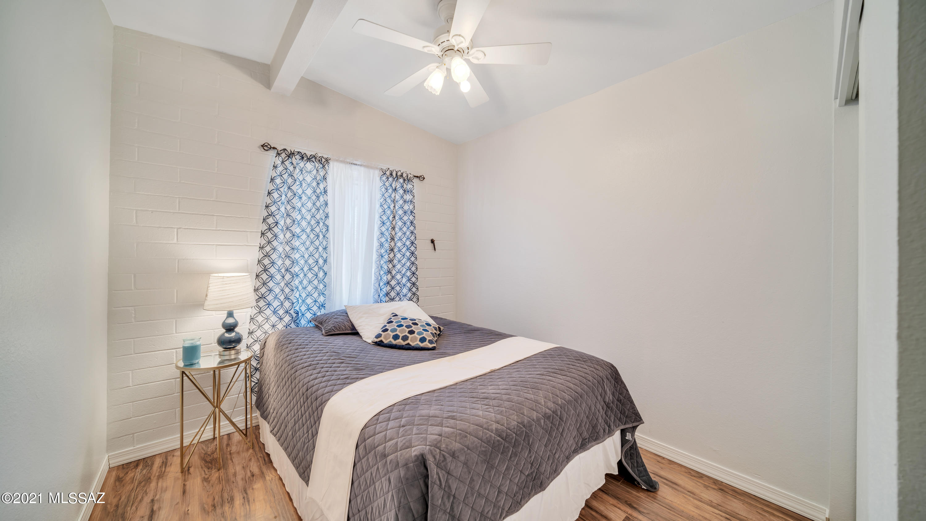 1850 West Saxony Road Tucson, AZ 85713 - Photo 17 of 33 a bed sitting in a bedroom next to a window and a chandelier