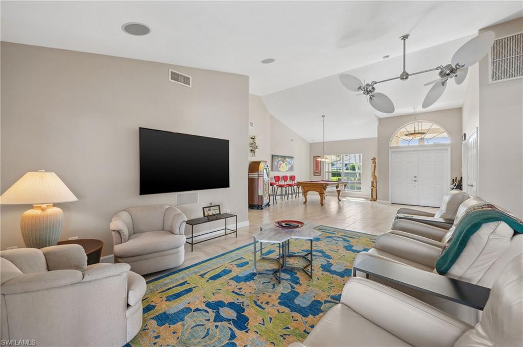 2104 Imperial Golf Course Boulevard Naples, FL 34110 - Photo 11 of 32 a living room with furniture and a flat screen tv
