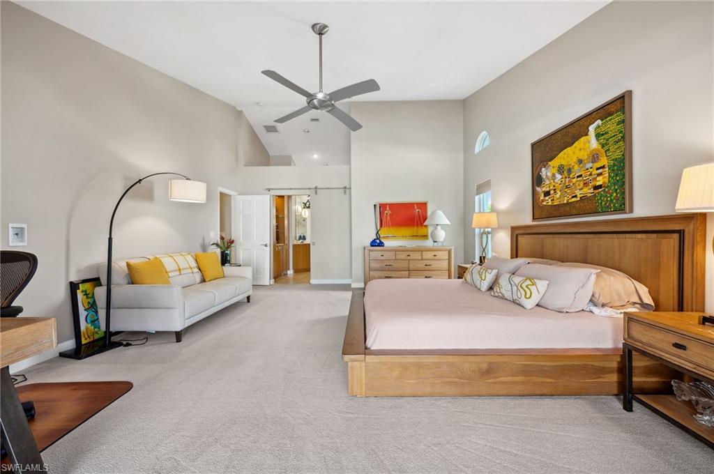 2104 Imperial Golf Course Boulevard Naples, FL 34110 - Photo 15 of 32 a bedroom with a bed a couch and dresser