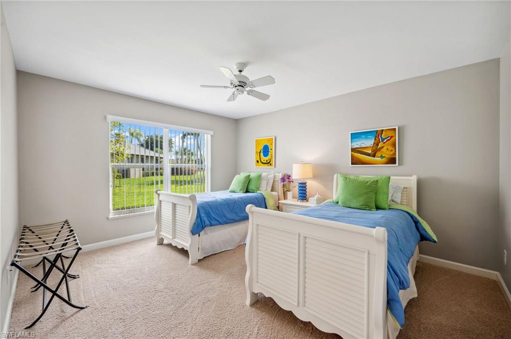 2104 Imperial Golf Course Boulevard Naples, FL 34110 - Photo 18 of 32 a bedroom with a bed and a chandelier