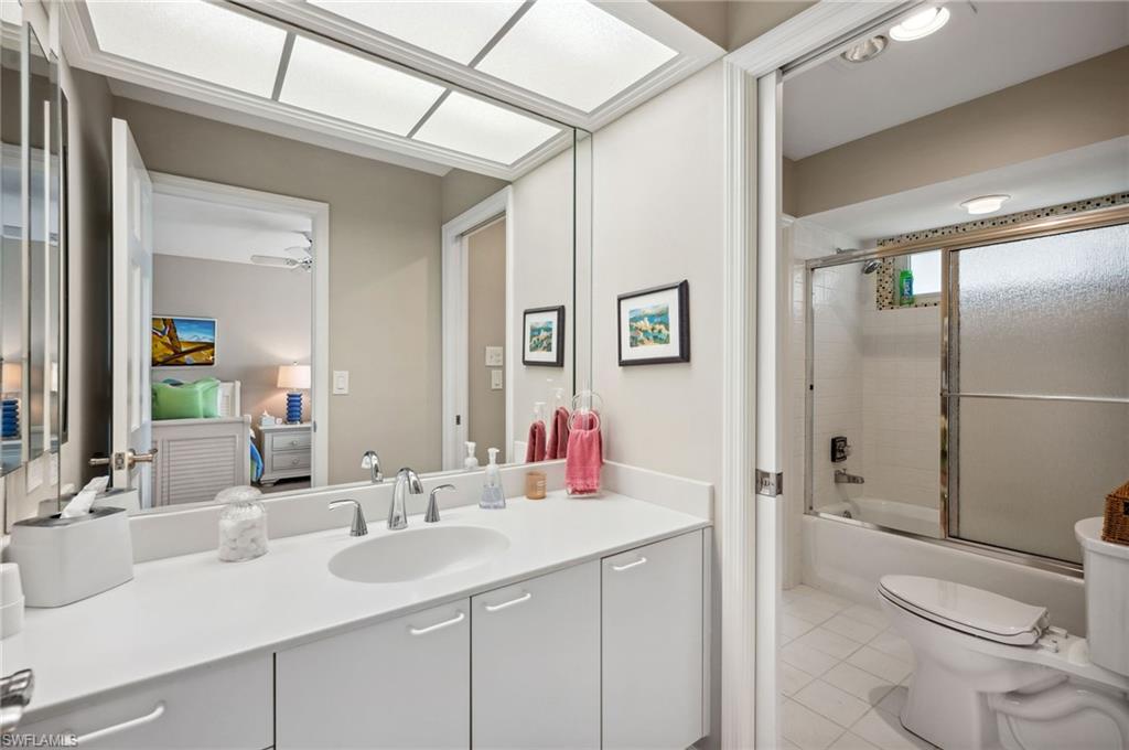 2104 Imperial Golf Course Boulevard Naples, FL 34110 - Photo 19 of 32 a bathroom with a sink toilet vanity and shower