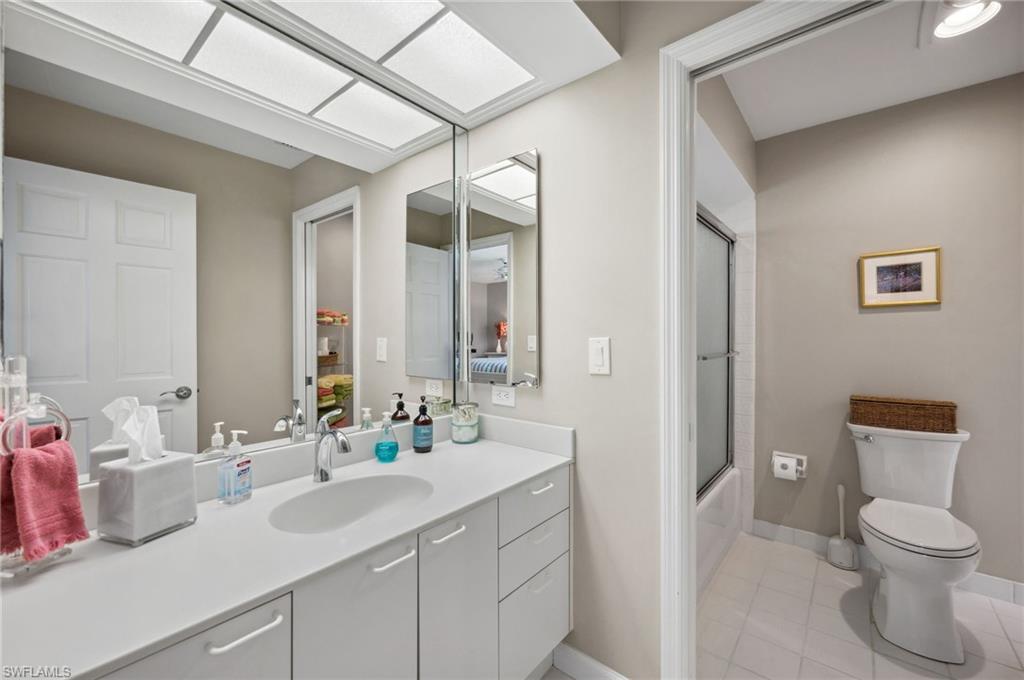 2104 Imperial Golf Course Boulevard Naples, FL 34110 - Photo 21 of 32 a bathroom with a toilet sink and mirror