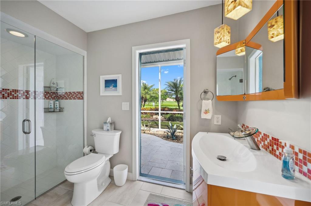 2104 Imperial Golf Course Boulevard Naples, FL 34110 - Photo 22 of 32 a bathroom with a sink toilet and shower