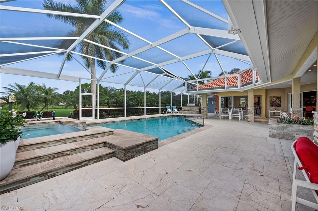 2104 Imperial Golf Course Boulevard Naples, FL 34110 - Photo 24 of 32 a view of a swimming pool with a patio