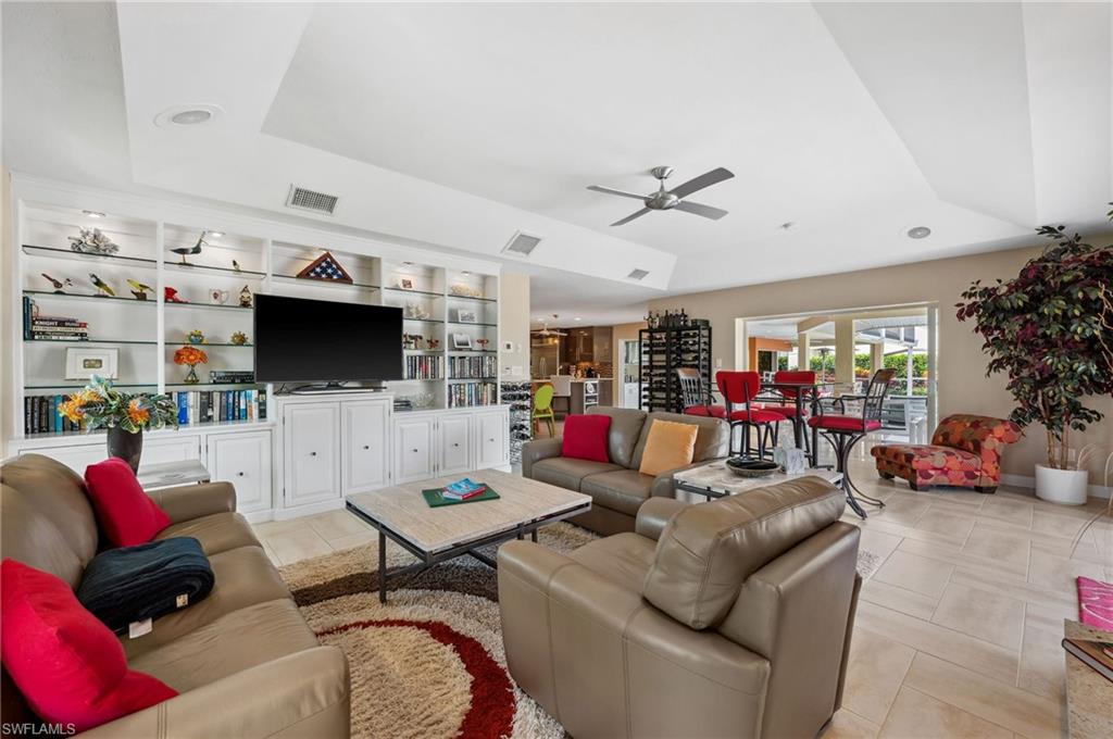 2104 Imperial Golf Course Boulevard Naples, FL 34110 - Photo 7 of 32 a living room with furniture and a flat screen tv