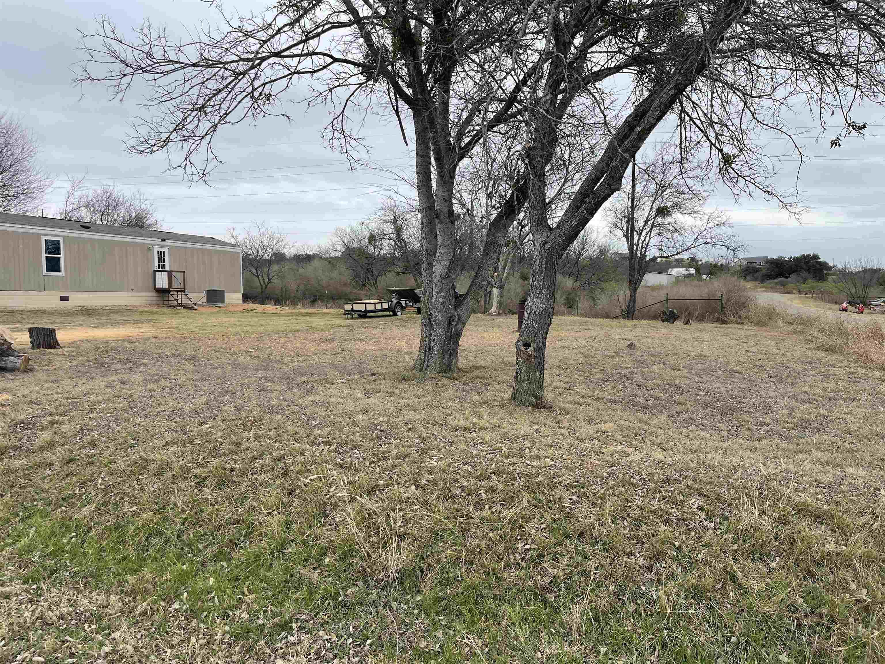 800 East Collins Street Llano, TX 78643 - Photo 2 of 2 a view of a yard with a tree