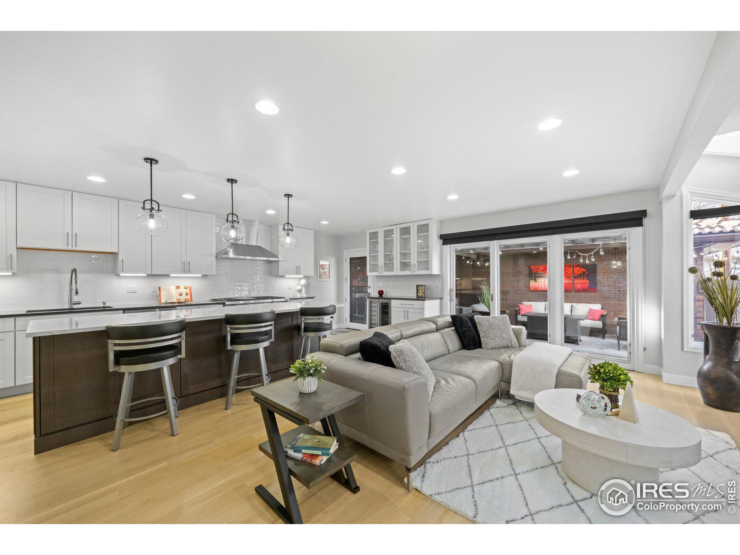 a living room with stainless steel appliances kitchen island granite countertop furniture and a kitchen view