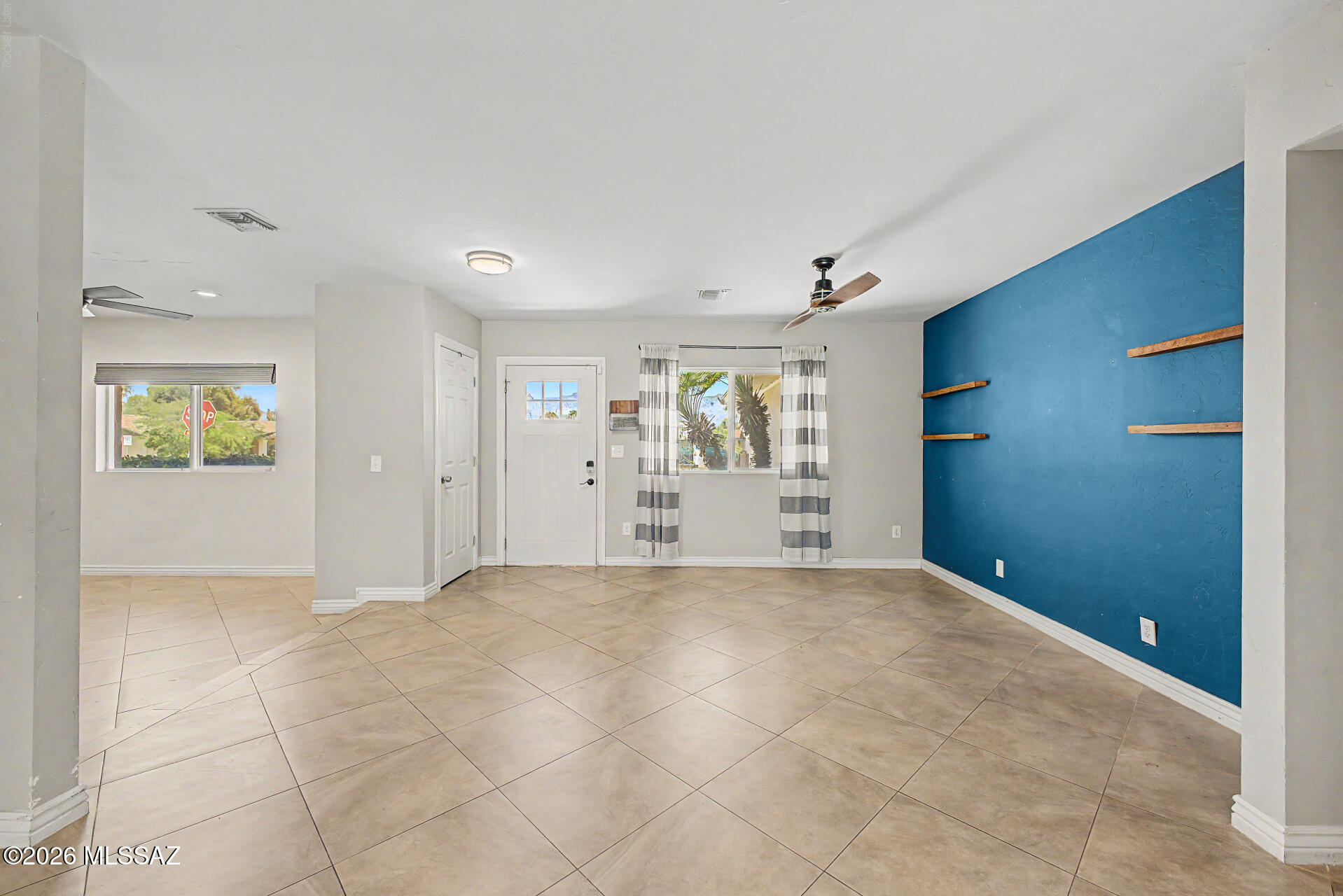 7550 East Rio Verde Drive Tucson, AZ 85715 - Photo 4 of 25 Step inside & be greeted by beautiful natural light & a stunning blue accent wall that instantly feels like home.