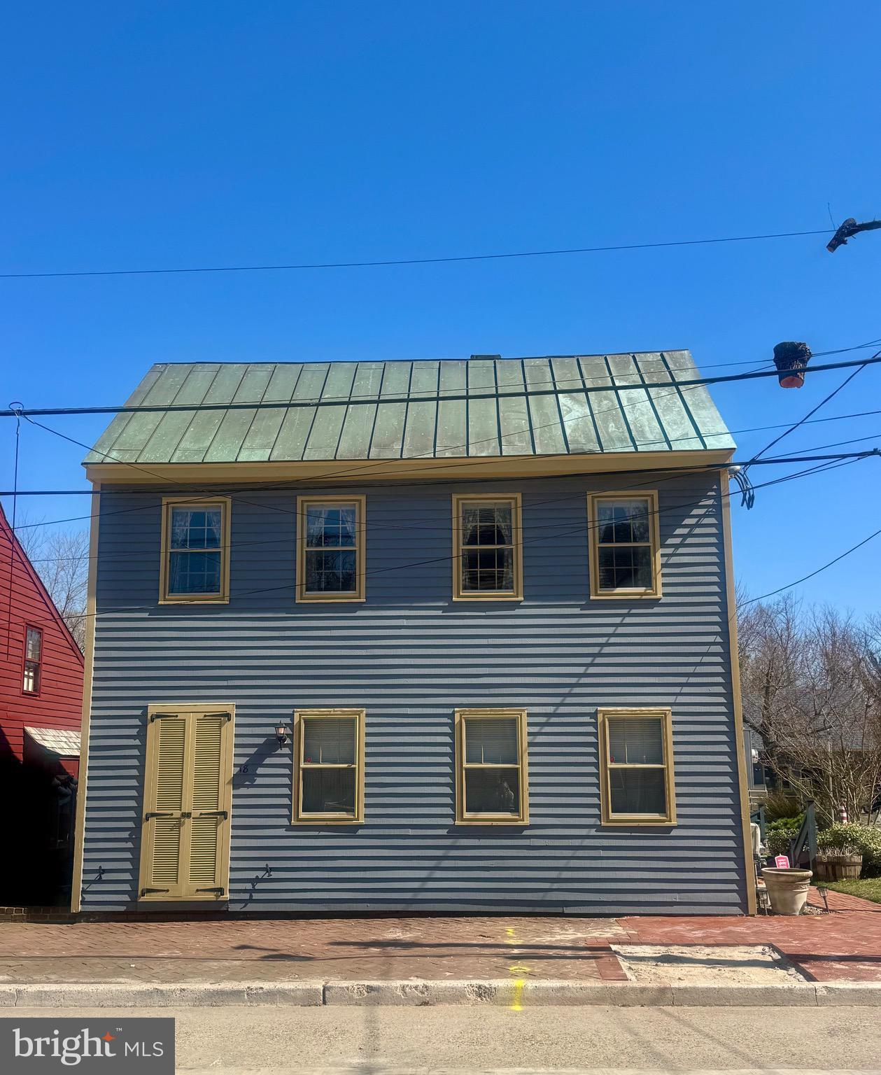 a view of a brick house with large windows