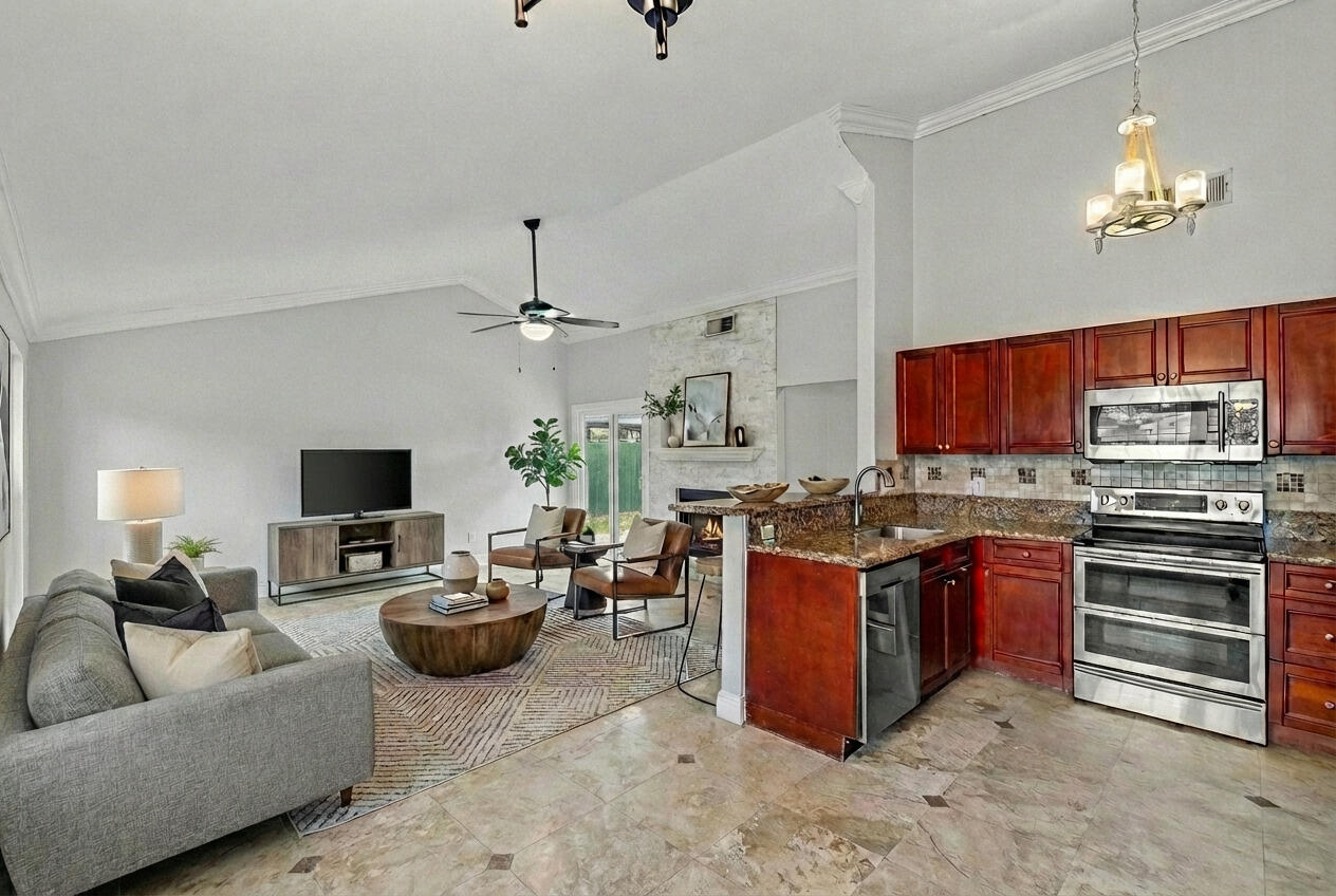 8411 Garden Gate Place Boca Raton, FL 33433 - Photo 1 of 12 a living room with stainless steel appliances granite countertop a stove and a living room