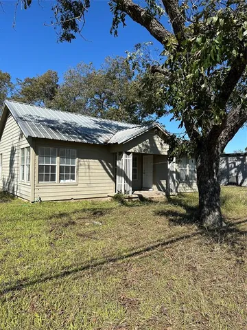 a view of a house with a tree in the background