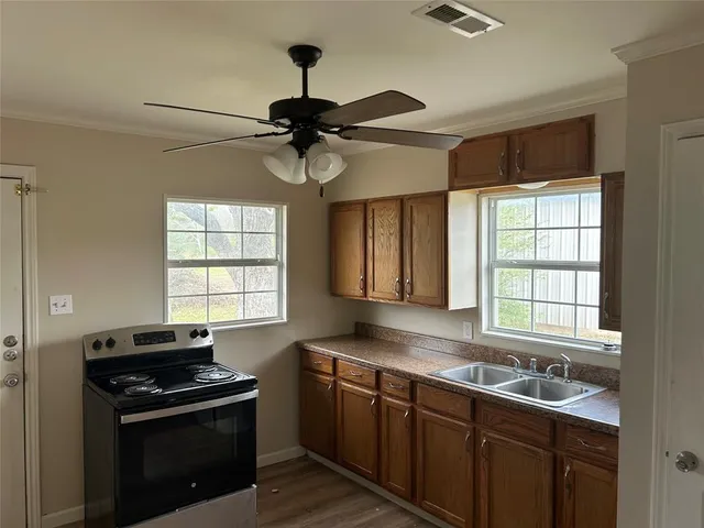a kitchen with stainless steel appliances a sink stove and window