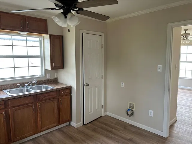 a bathroom with a granite countertop sink a mirror and shower