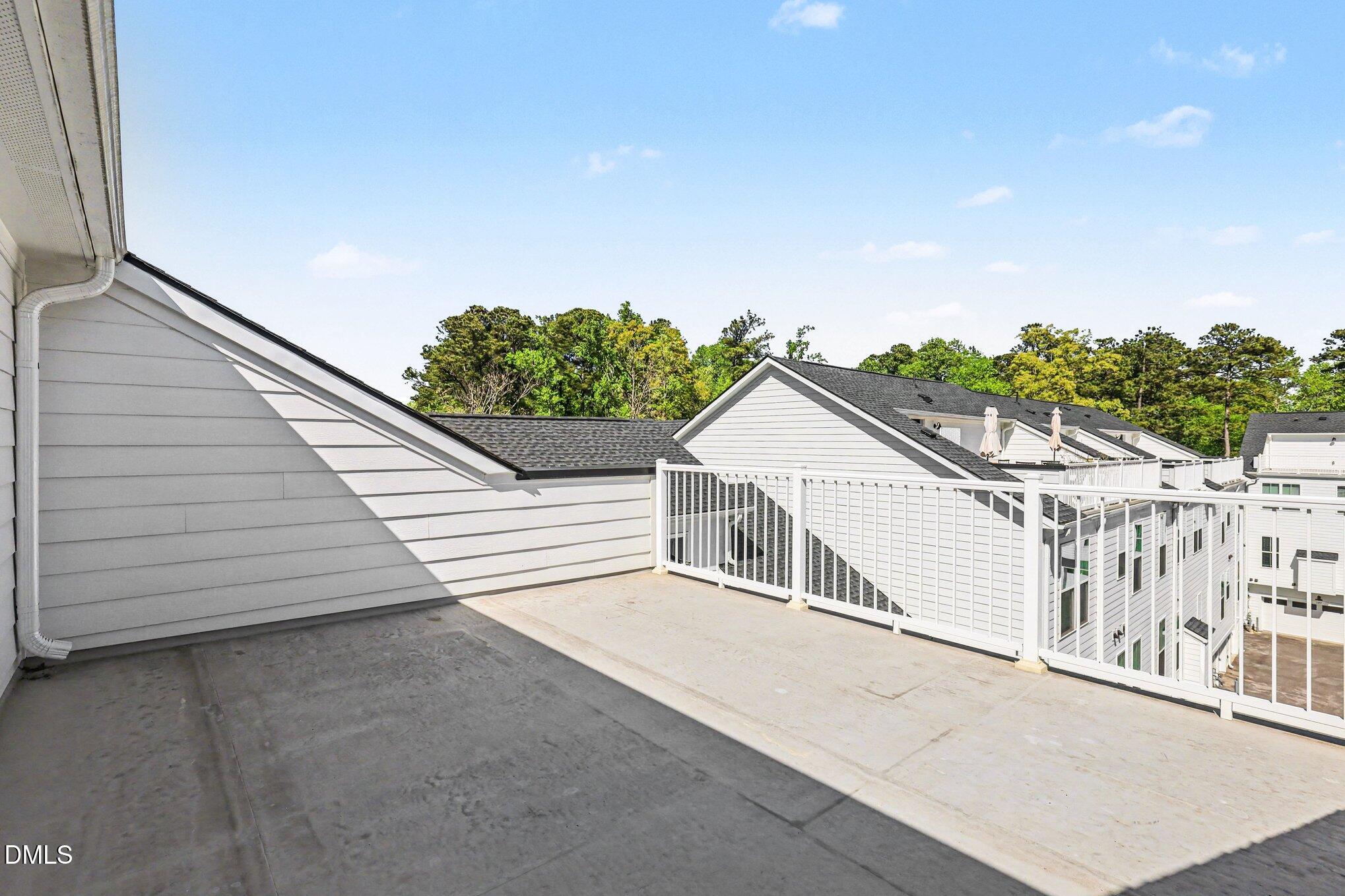 11549 Helmond Way, Unit 115 Raleigh, NC 27617 - Photo 21 of 25 a white building with a large window and wooden fence