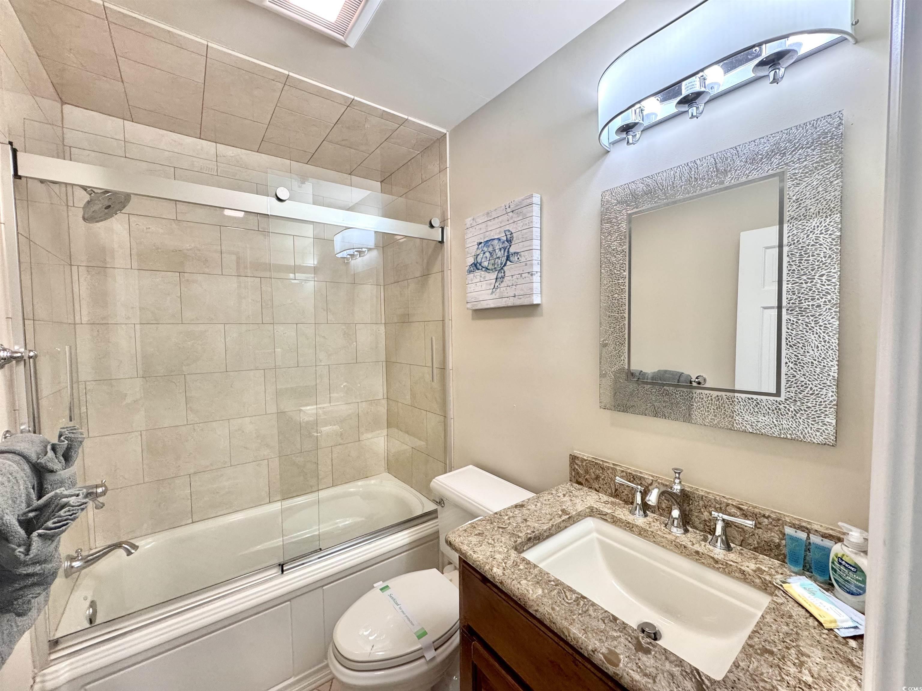 1111 North Ocean Boulevard, Unit 305 Surfside Beach, SC 29575 - Photo 19 of 38 Full bath featuring granite top vanity and enclosed tub / shower combo