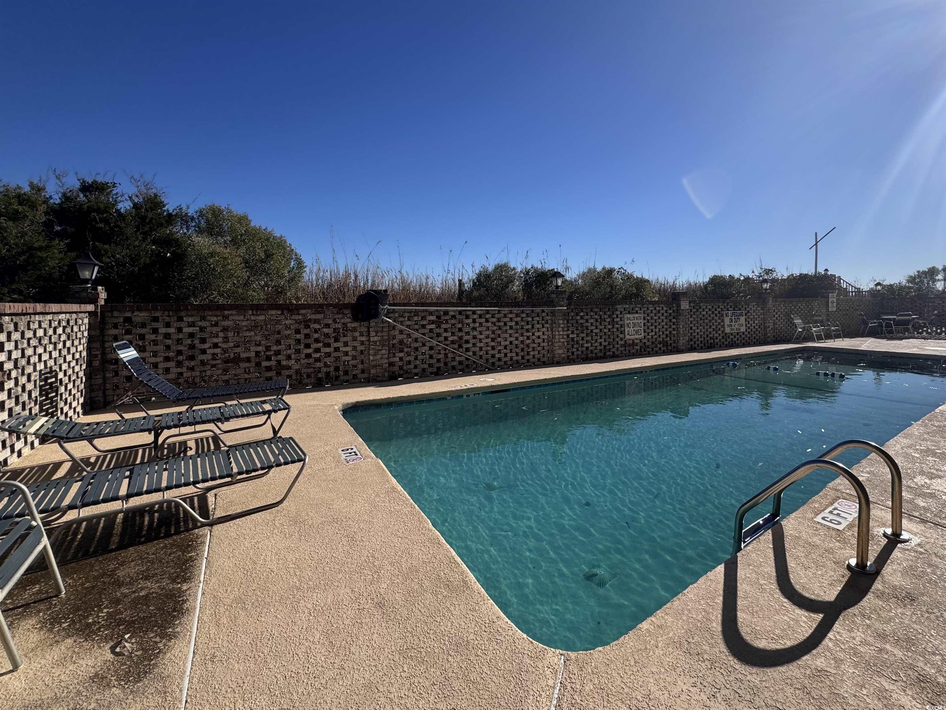 1111 North Ocean Boulevard, Unit 305 Surfside Beach, SC 29575 - Photo 32 of 38 Community pool with a patio