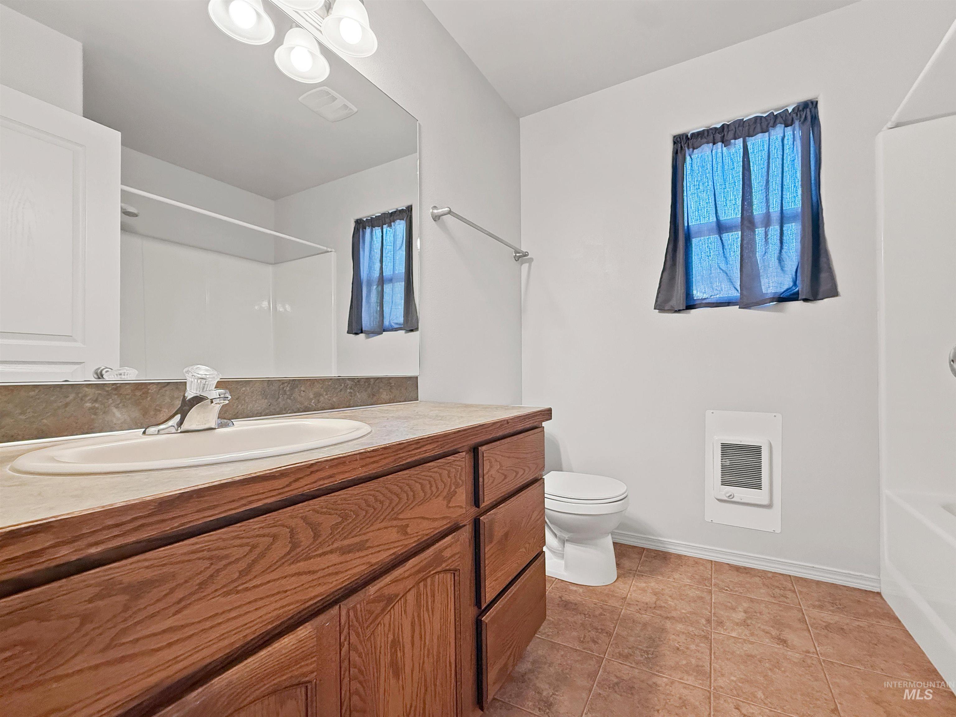 1354 Bristol Road Moscow, ID 83843 - Photo 12 of 19 Bathroom featuring a wood-finish vanity with an integrated sink and laminate countertop