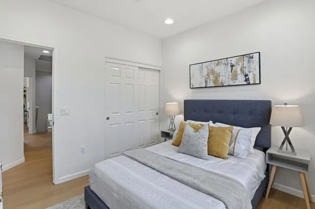 a bedroom with a bed and a painting on the wall