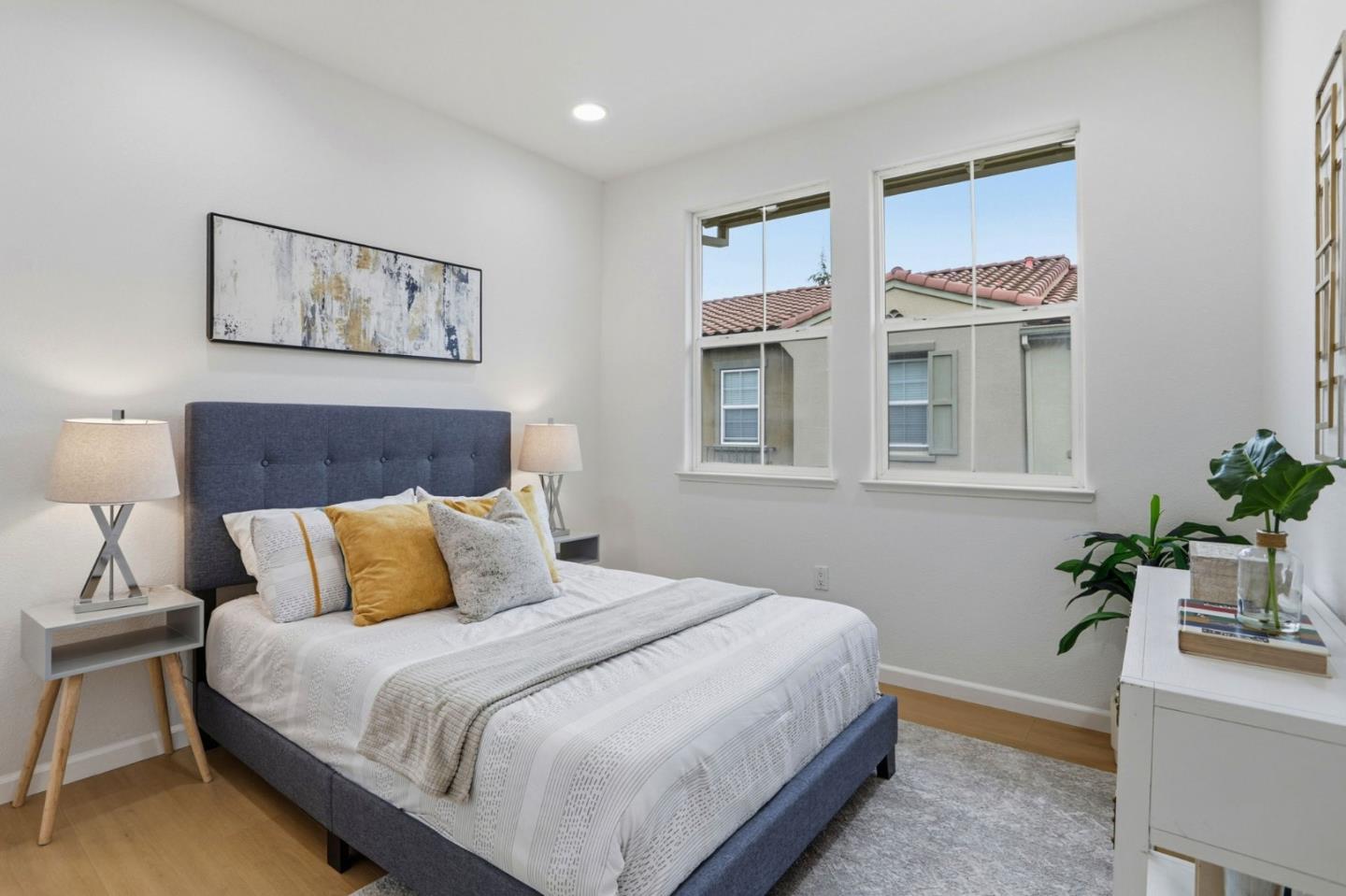 745 Mente Linda Loop Milpitas, CA 95035 - Photo 20 of 33 a bedroom with a large bed and paintings on the wall