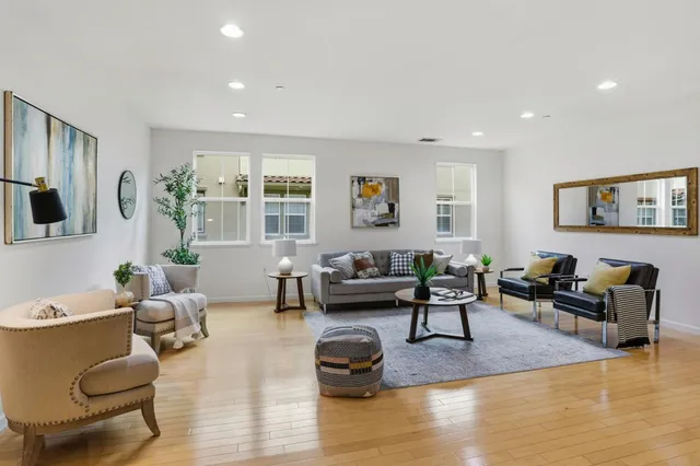a living room with furniture window and a wooden floor