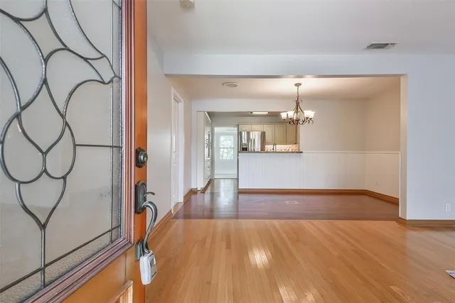 a view of a room with wooden floor and bench