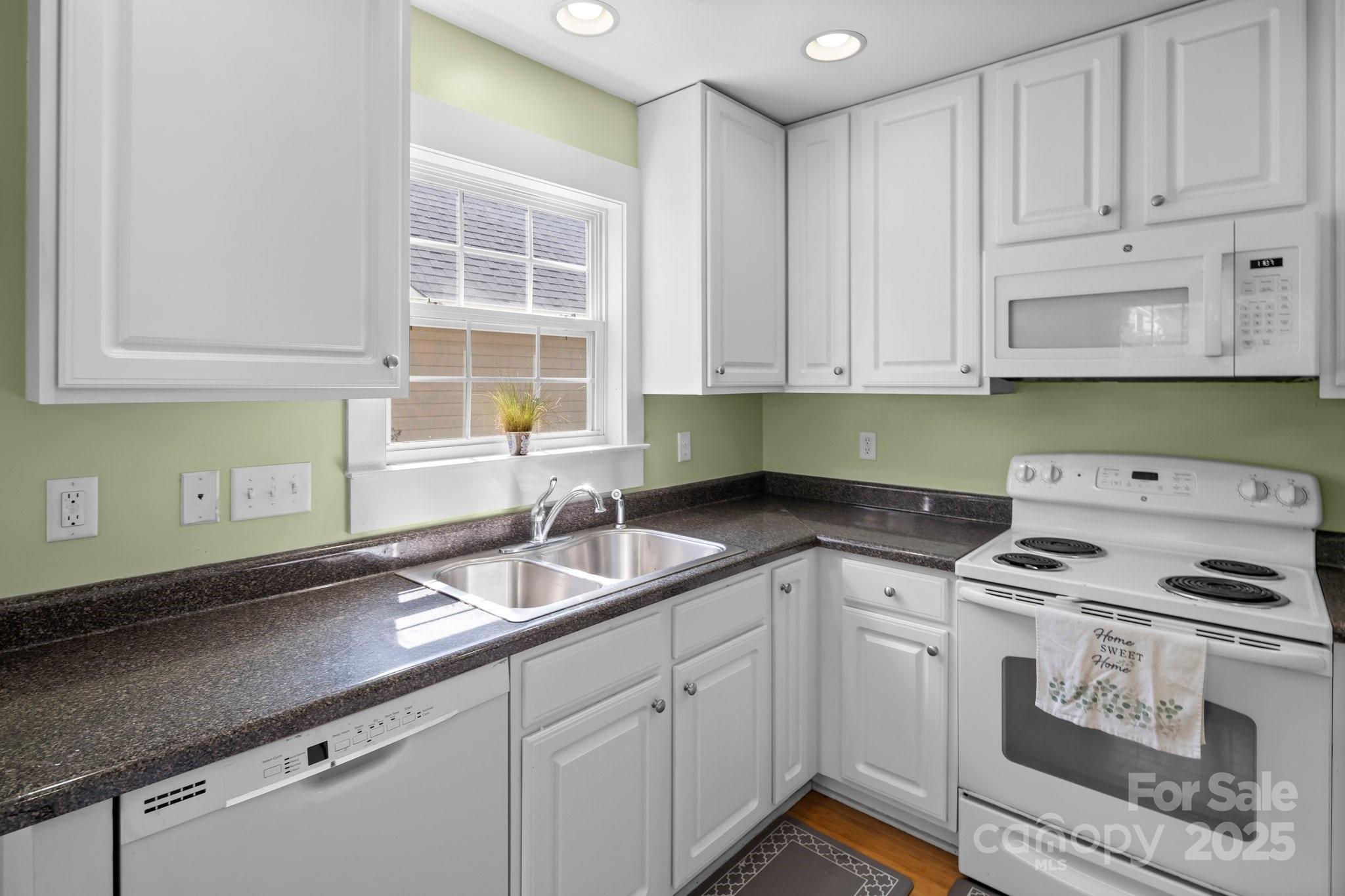 160 Lumber River Road Fletcher, NC 28732 - Photo 7 of 23 a kitchen with granite countertop a sink a stove and cabinets