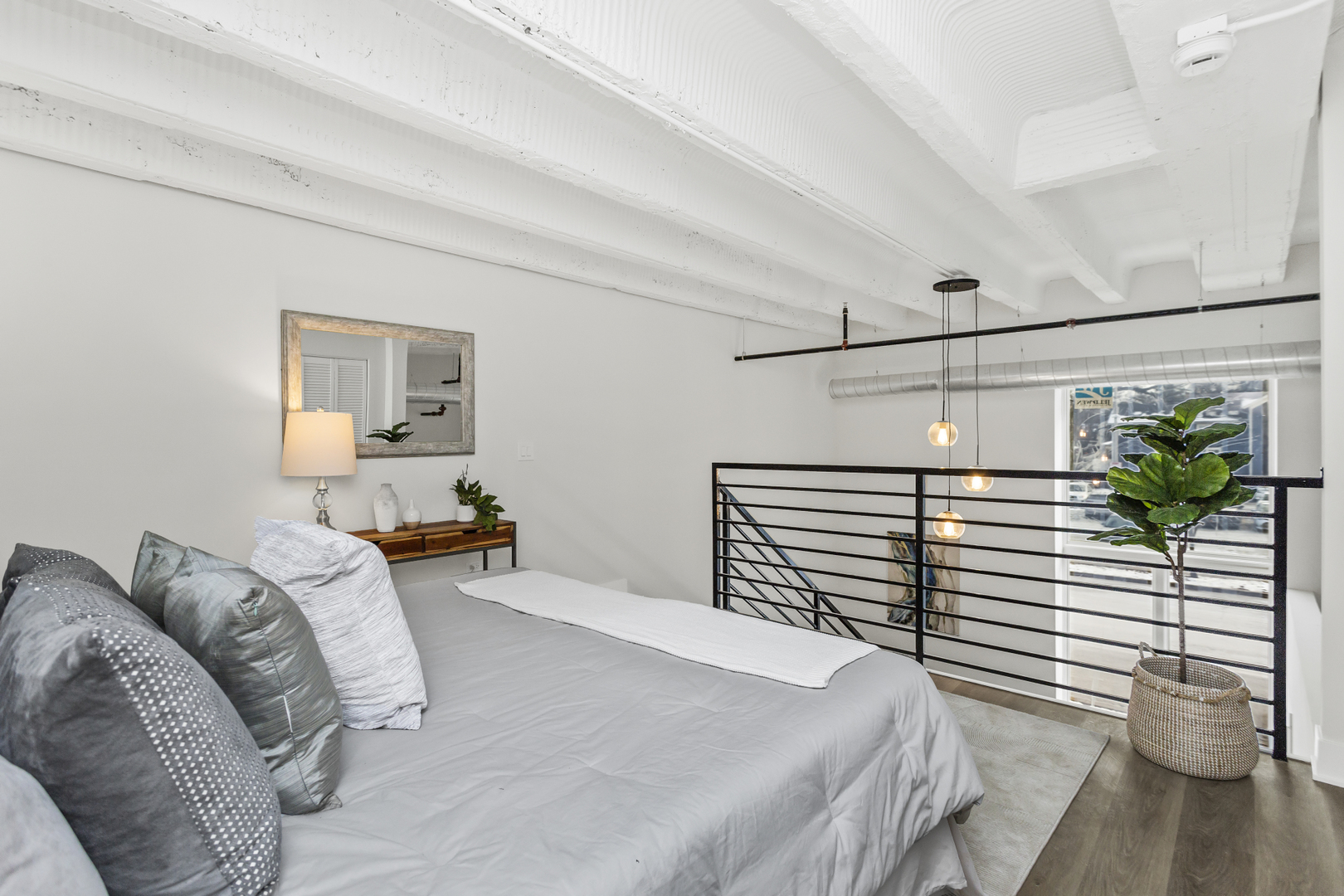 1453 Maple Avenue, Unit 102 Evanston, IL 60201 - Photo 12 of 21 a bedroom with a bed and a potted plant