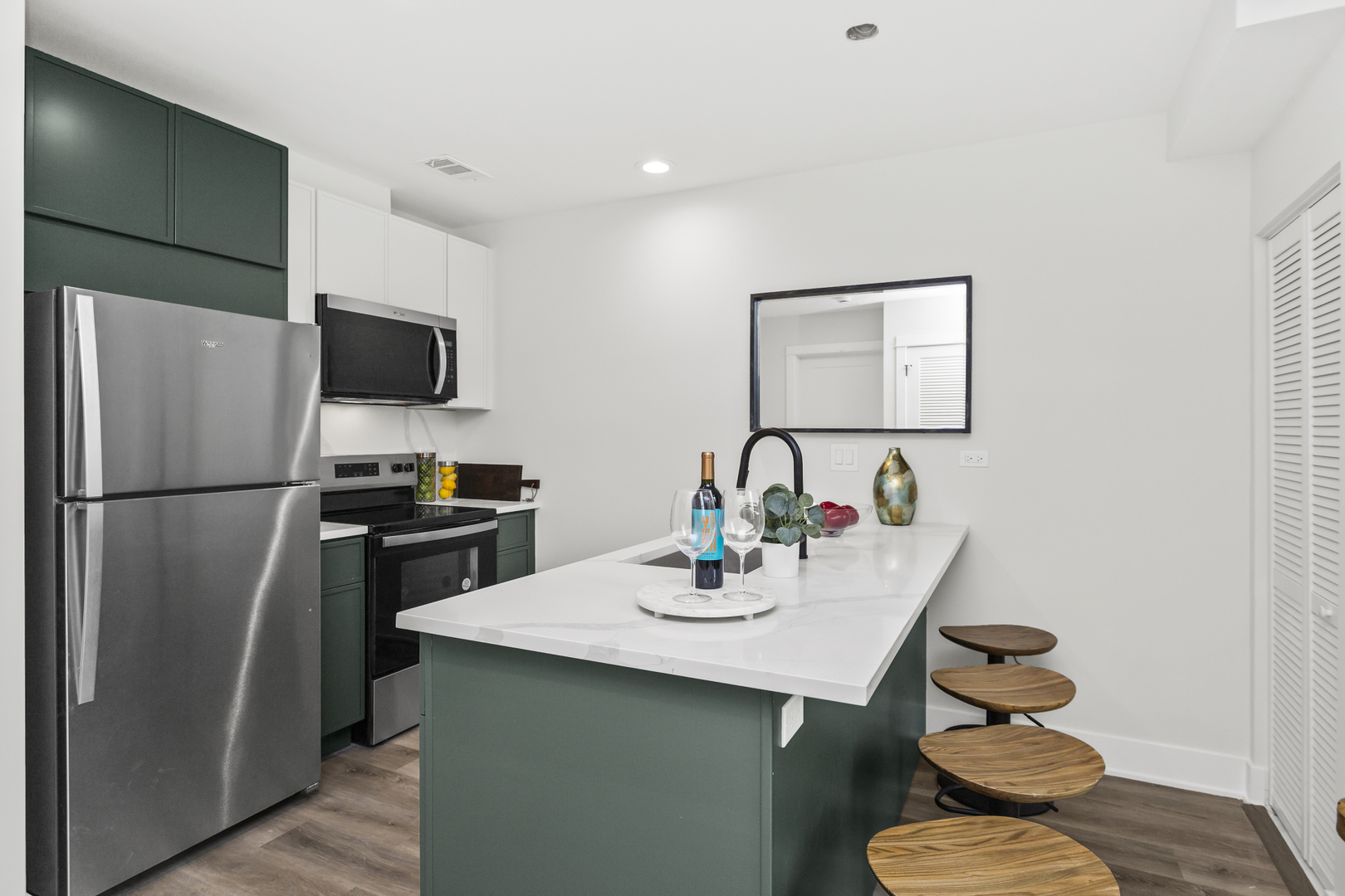 1453 Maple Avenue, Unit 102 Evanston, IL 60201 - Photo 5 of 21 a kitchen with a sink refrigerator and microwave