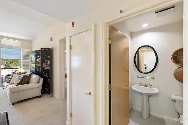 a bathroom with a toilet a sink and a mirror