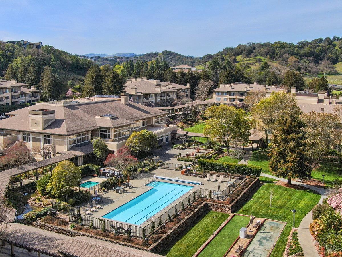 400 Deer Valley Road, Unit 4D San Rafael, CA 94903 - Photo 37 of 50 Generous lap pool, spa and patio with lounge chairs, tables and umbrellas