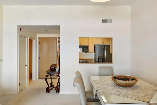 a living room with furniture and large windows