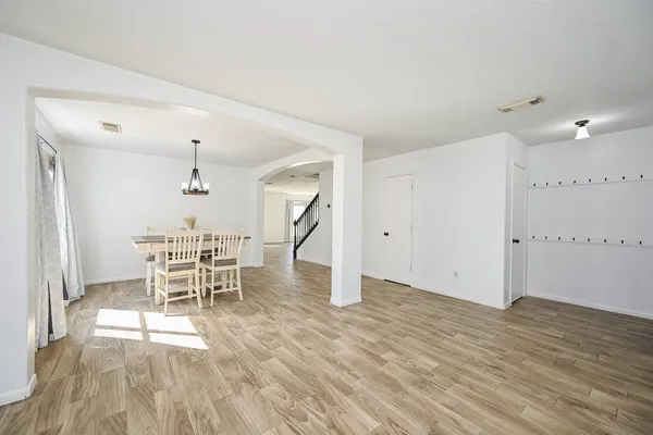 a view of a bedroom with wooden floor and windows
