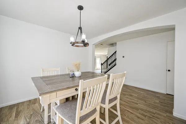 an empty room with wooden floor and bench