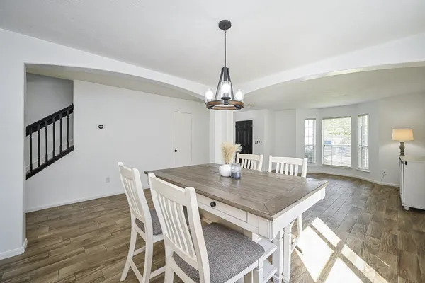 a view of a dining room with furniture and wooden floor