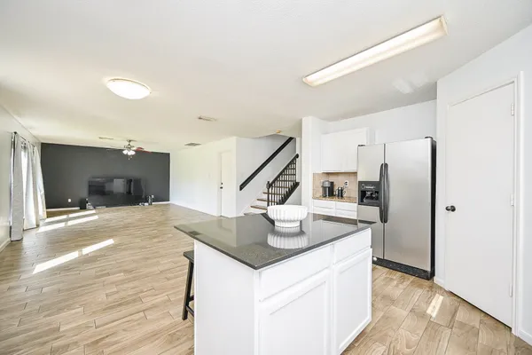 a kitchen with a sink cabinets and wooden floor