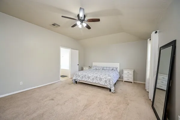 a view of room with a ceiling fan and wooden floor