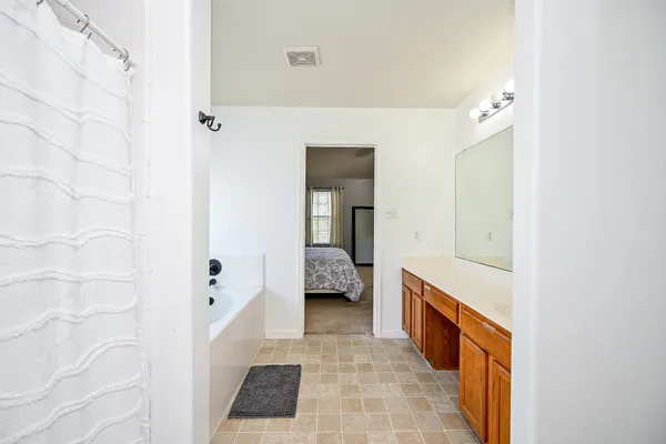 a bathroom with a bathtub and a shower