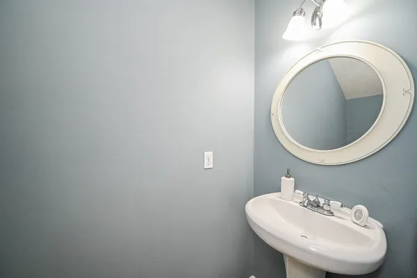 a bathroom with a sink a toilet and mirror
