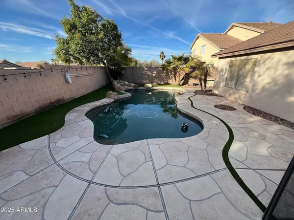 a view of a swimming pool and lounge chair