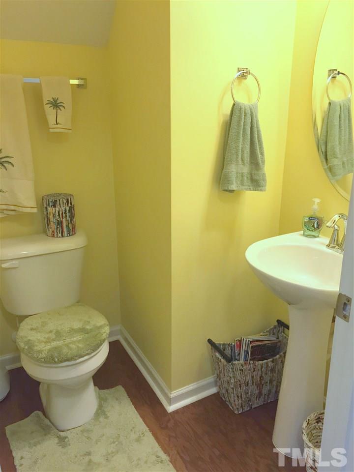 1925 Raj Drive Durham, NC 27703 - Photo 12 of 25 Powder room off the kitchen with pedestal sink and hardwood floors
