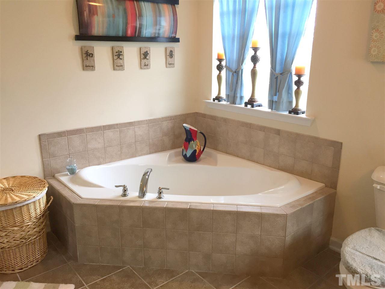 1925 Raj Drive Durham, NC 27703 - Photo 15 of 25 HUGE master bathroom! Separate garden tub with ceramic tile surround and large window for natural light.