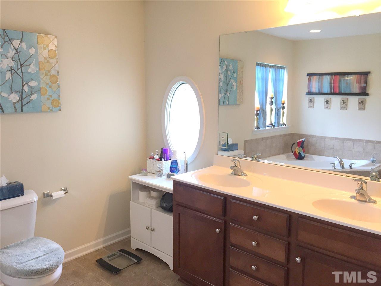 1925 Raj Drive Durham, NC 27703 - Photo 17 of 25 Dual vanities with marble counter tops. There's an extra vanity area next to the right sink with room for a chair or stool. Decorative window for added natural light.