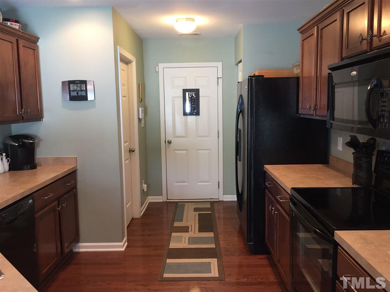1925 Raj Drive Durham, NC 27703 - Photo 6 of 25 Beautiful hardwood floors! Door leads to garage. Good size pantry next to fridge and powder room to the left.