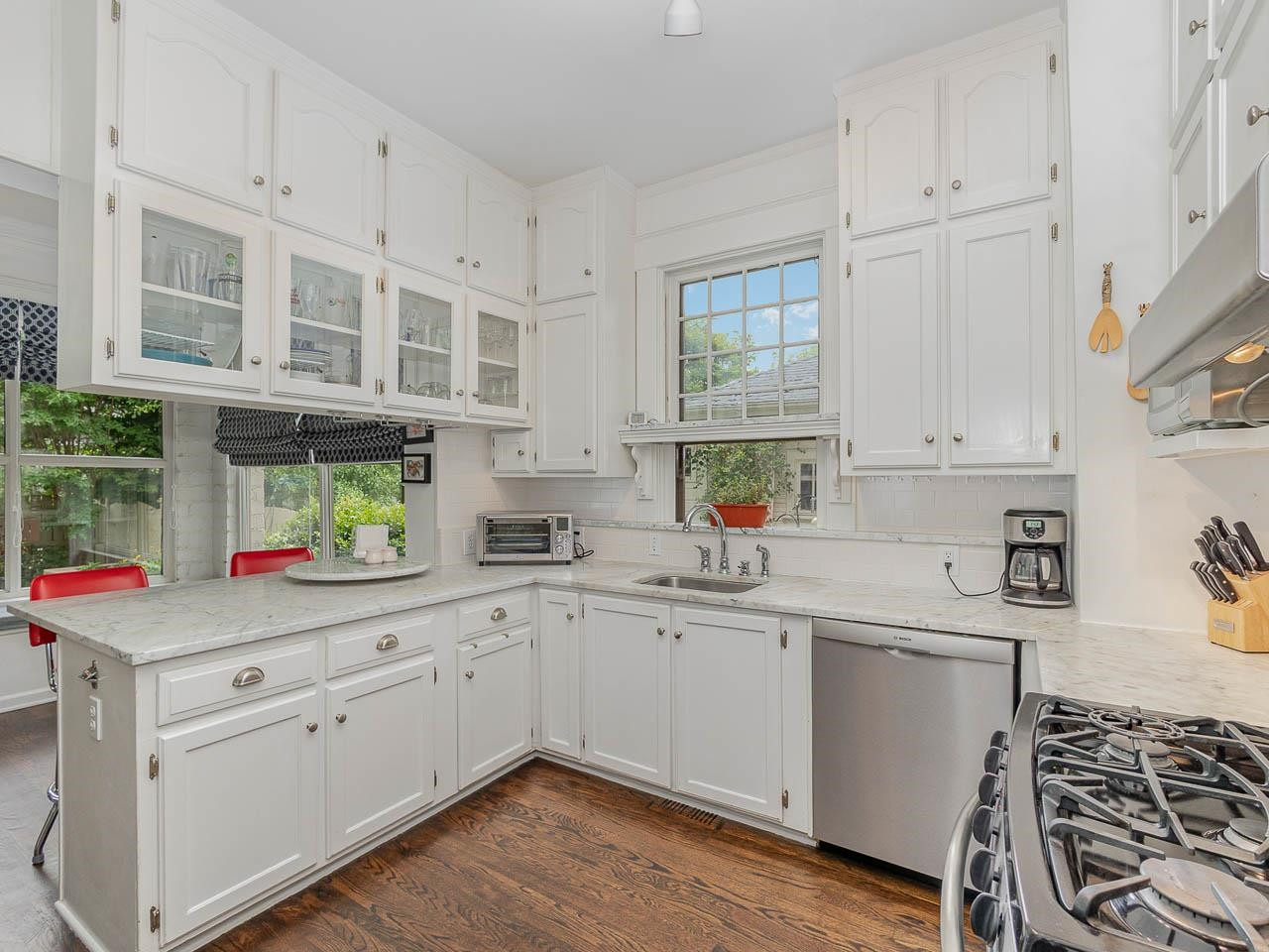 401 West Whitaker Mill Road Raleigh, NC 27608 - Photo 20 of 30 Beautiful Kitchen with marble counters, '22 Bosch dishwasher and newer stainless steel refirgerator. Kitchen
