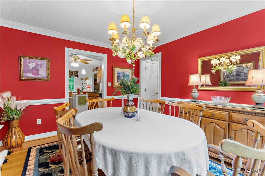 2655 Dorset Ridge Road Powhatan, VA 23139 - Photo 22 of 50 Dining area featuring wood finished floors, crown